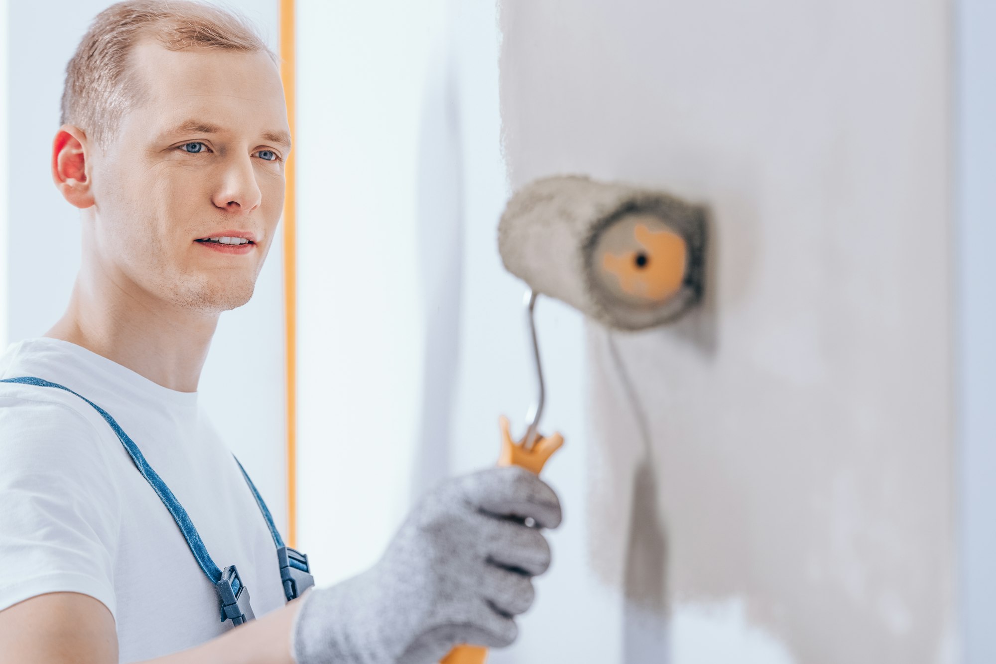 Worker using paint roller